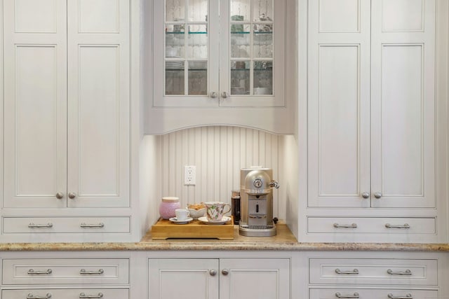 bar featuring white cabinets