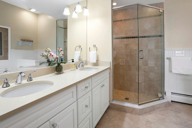 bathroom featuring tile patterned flooring, vanity, baseboard heating, and a shower with shower door