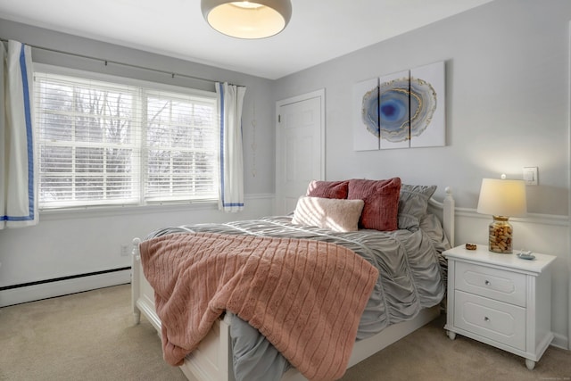 carpeted bedroom featuring a baseboard heating unit