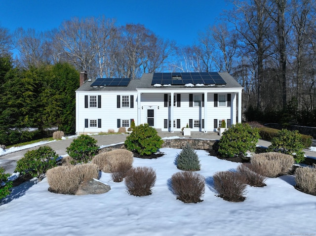 view of front of property with solar panels and a porch