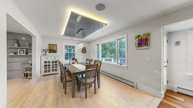 dining room featuring baseboard heating and light hardwood / wood-style floors