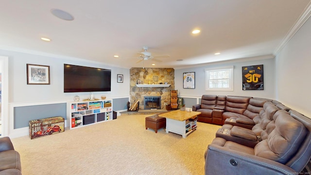 carpeted living room featuring crown molding, ceiling fan, and a fireplace