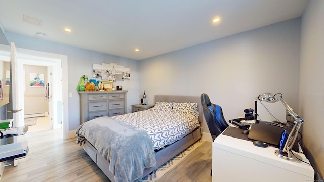 bedroom featuring a baseboard radiator and light wood-type flooring