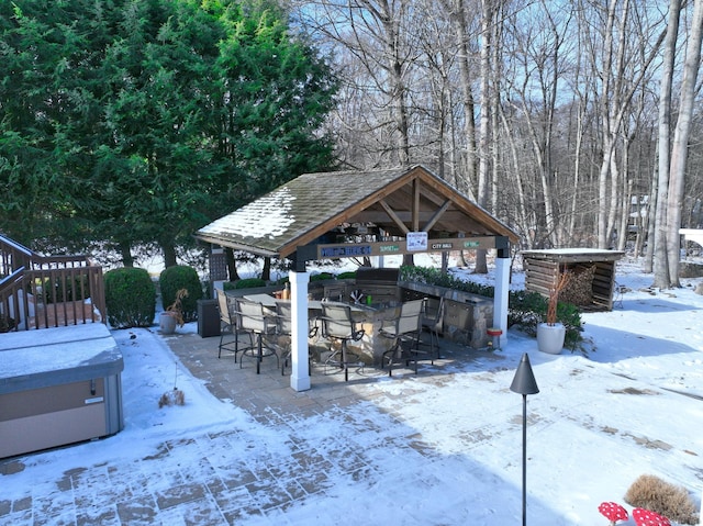 exterior space featuring a bar, a hot tub, and a gazebo