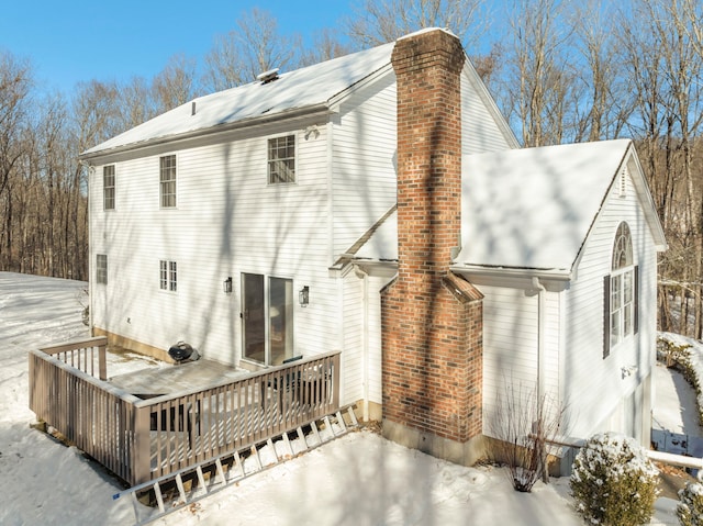 snow covered property featuring a wooden deck