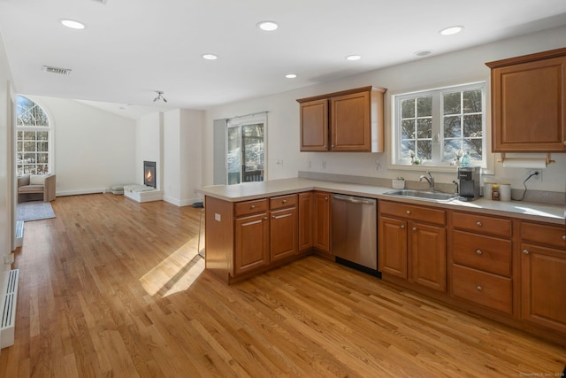 kitchen featuring sink, light hardwood / wood-style flooring, kitchen peninsula, and stainless steel dishwasher