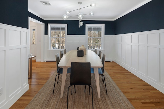 dining room featuring light wood-type flooring and a healthy amount of sunlight