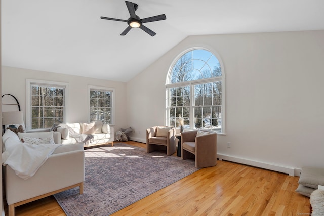 living room with ceiling fan, light wood-type flooring, and lofted ceiling