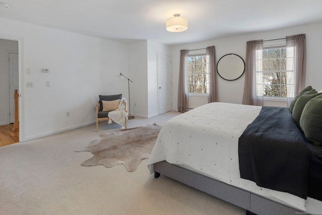 carpeted bedroom featuring multiple windows