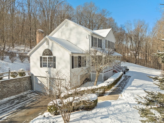 snow covered property featuring a garage