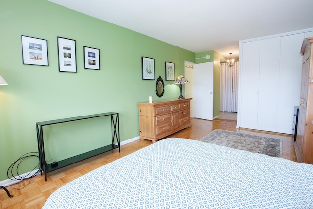 bedroom featuring light parquet floors and a chandelier