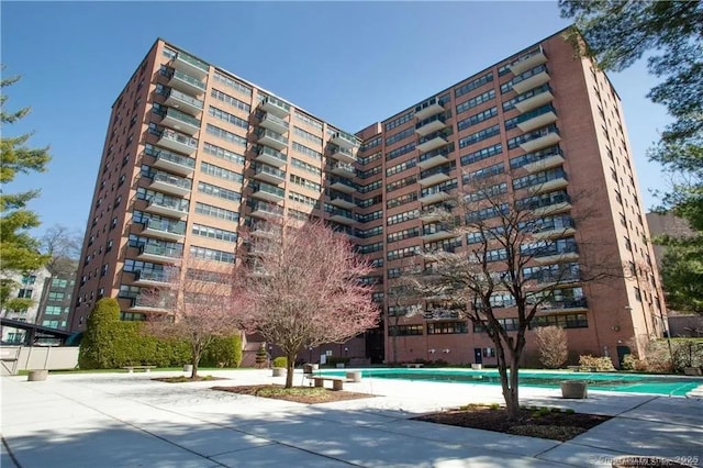 view of building exterior featuring a community pool