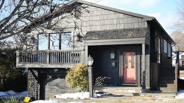 view of front facade featuring a balcony and a garage