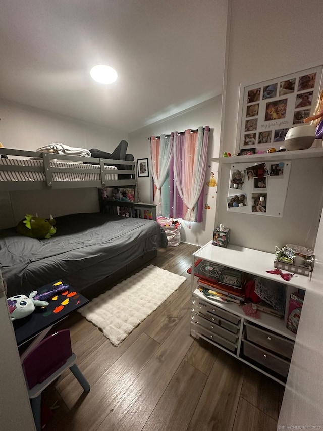 bedroom with dark wood-type flooring