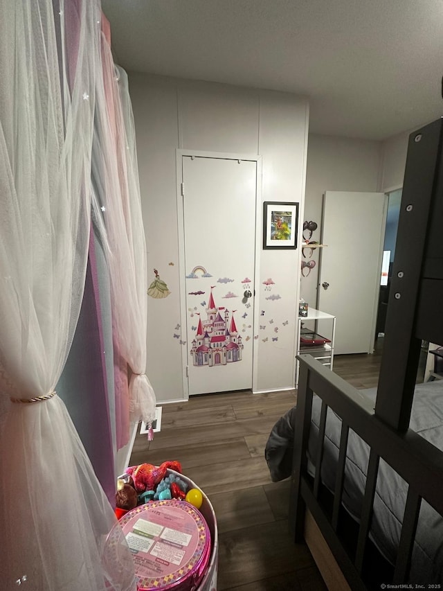 bedroom with dark wood-type flooring