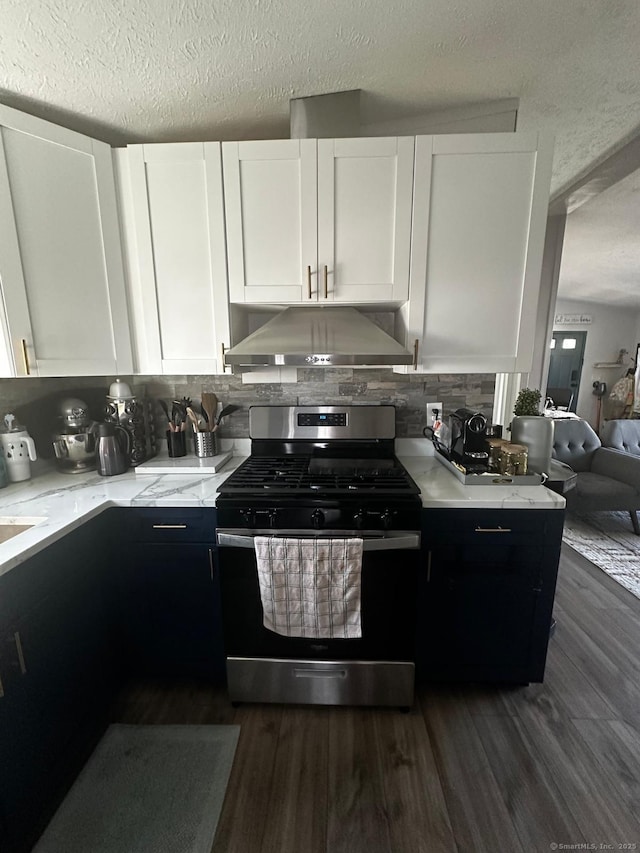 kitchen with tasteful backsplash, a textured ceiling, stainless steel range with gas stovetop, and white cabinets