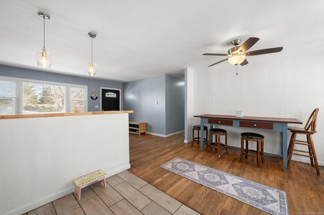 interior space featuring hanging light fixtures and dark hardwood / wood-style flooring