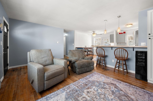 living room featuring ceiling fan, dark wood-type flooring, and beverage cooler