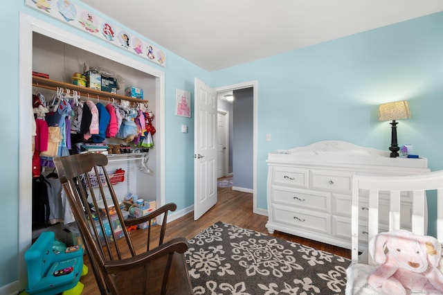 bedroom with dark wood-type flooring and a closet