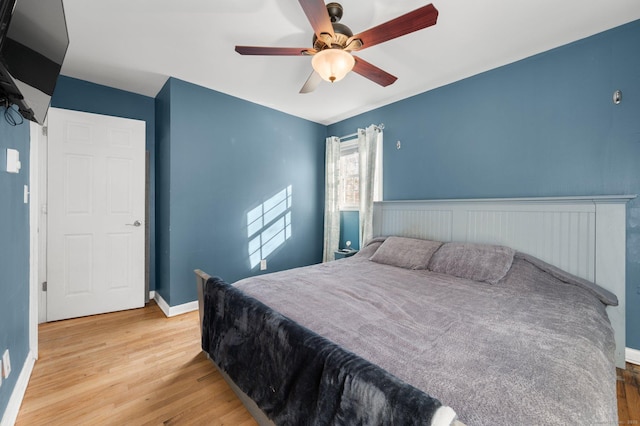 bedroom with ceiling fan and wood-type flooring