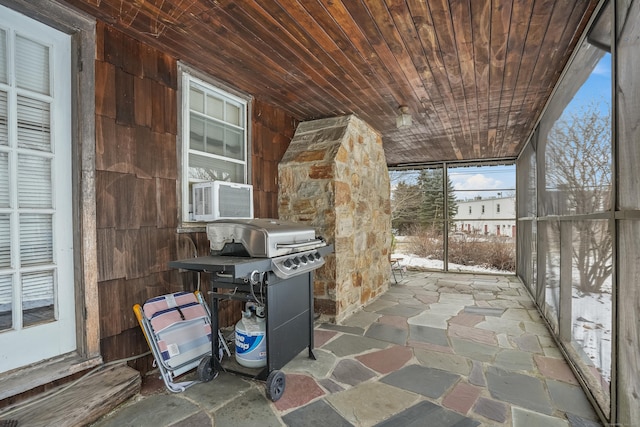 unfurnished sunroom featuring cooling unit and wooden ceiling