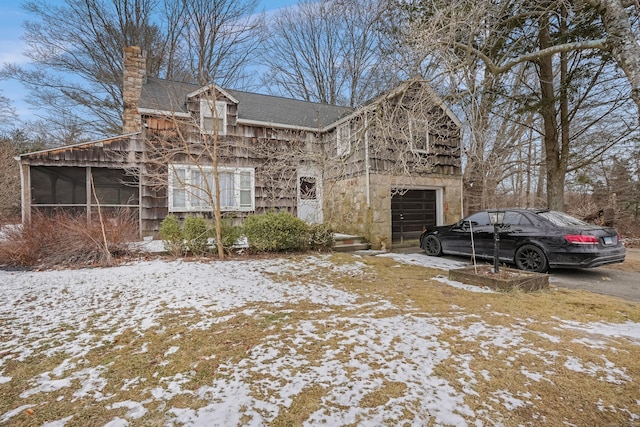 view of front of house with a garage and a sunroom