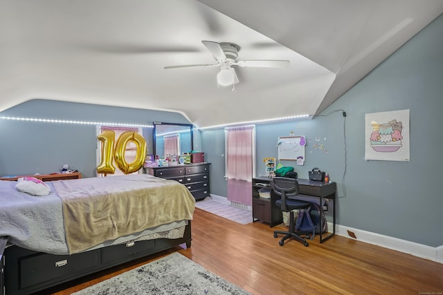 bedroom with ceiling fan, hardwood / wood-style floors, and lofted ceiling