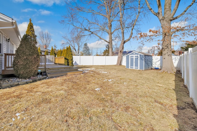 63 Contact Dr, West Haven, CT 06516 - view of yard featuring a storage unit, a fenced backyard, a wooden deck, and an outbuilding