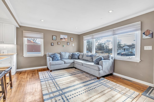 63 Contact Dr, West Haven, CT 06516 - living room featuring crown molding, baseboards, visible vents, and light wood-style flooring