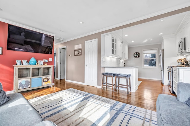 63 Contact Dr, West Haven, CT 06516 - living area with baseboards, ornamental molding, light wood finished floors, and recessed lighting