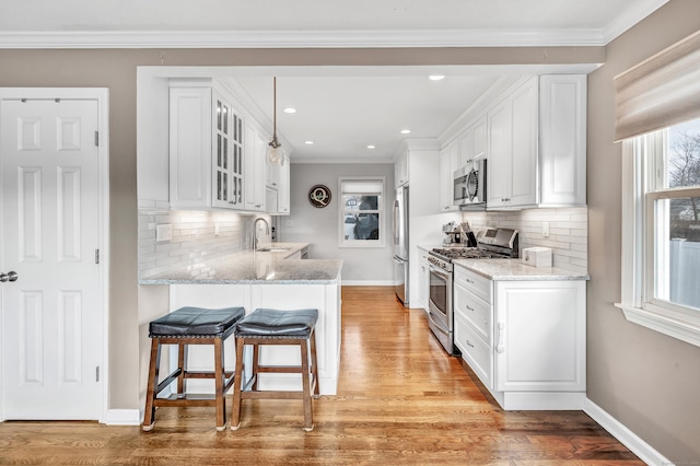 63 Contact Dr, West Haven, CT 06516 - kitchen with a sink, appliances with stainless steel finishes, white cabinets, and a healthy amount of sunlight