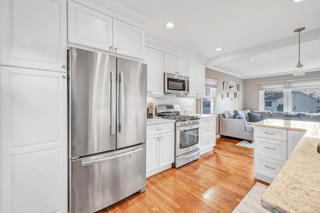 63 Contact Dr, West Haven, CT 06516 - kitchen featuring white cabinets, open floor plan, light wood-style floors, ornamental molding, and stainless steel appliances