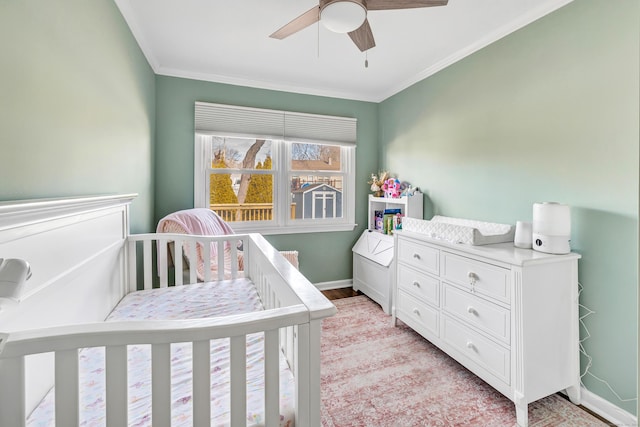 63 Contact Dr, West Haven, CT 06516 - bedroom with baseboards, ornamental molding, a crib, and ceiling fan