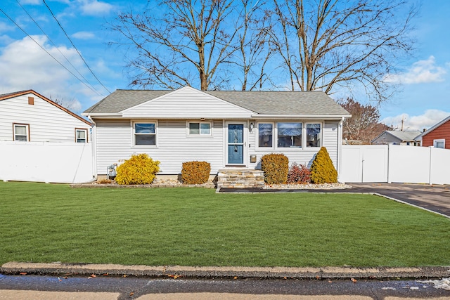 63 Contact Dr, West Haven, CT 06516 - view of front of house with fence, a shingled roof, and a front lawn