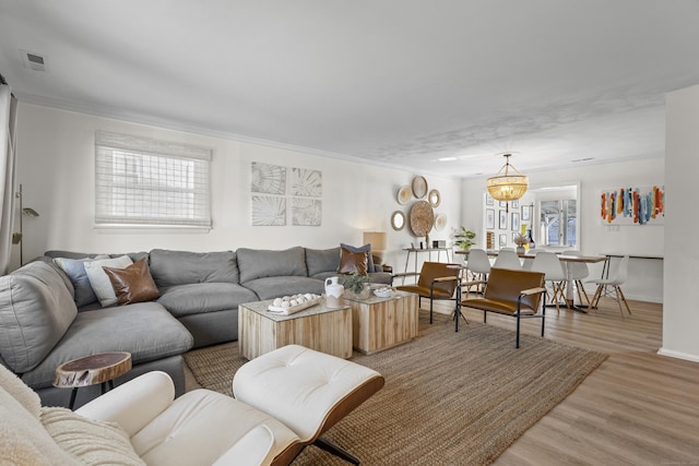 living room with hardwood / wood-style flooring and crown molding