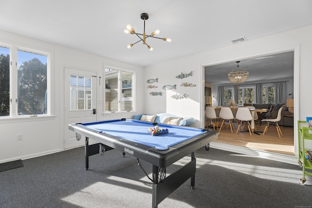 game room with carpet and a chandelier