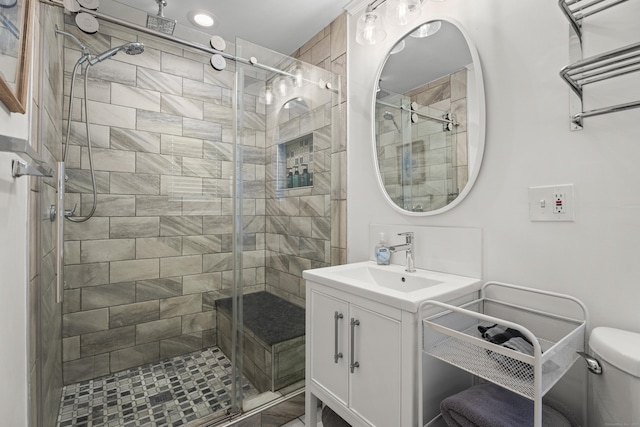 bathroom with vanity, a shower with shower door, and toilet