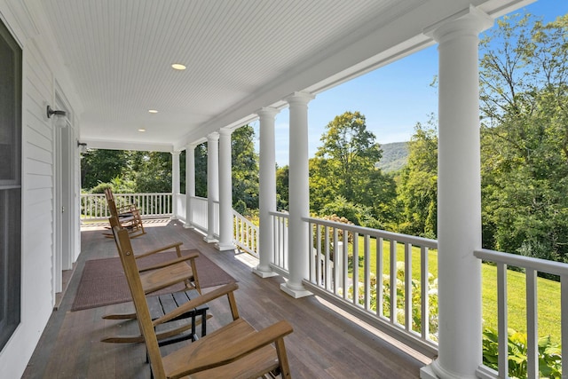 wooden terrace featuring covered porch