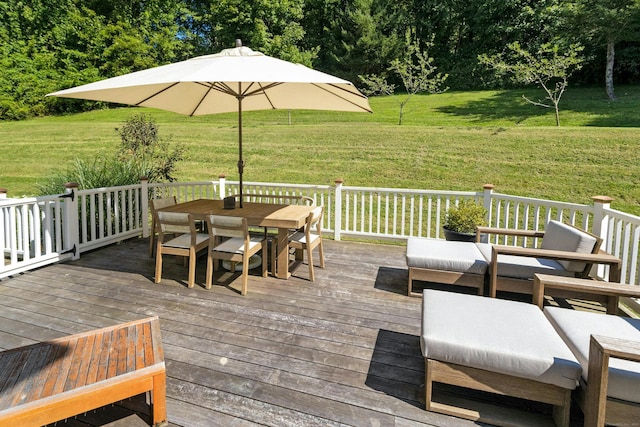 wooden deck with a lawn and outdoor dining space