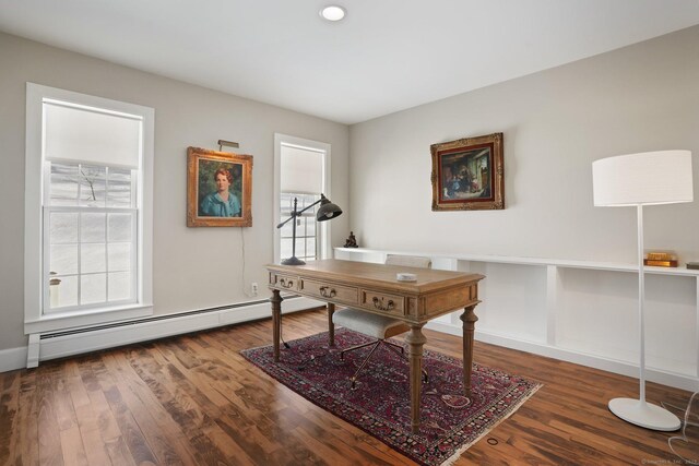 office area featuring a baseboard heating unit and wood finished floors