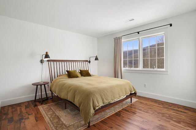 bedroom featuring baseboards and wood finished floors