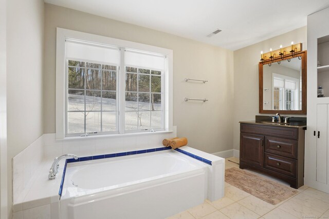 bathroom with a bath, marble finish floor, vanity, and visible vents