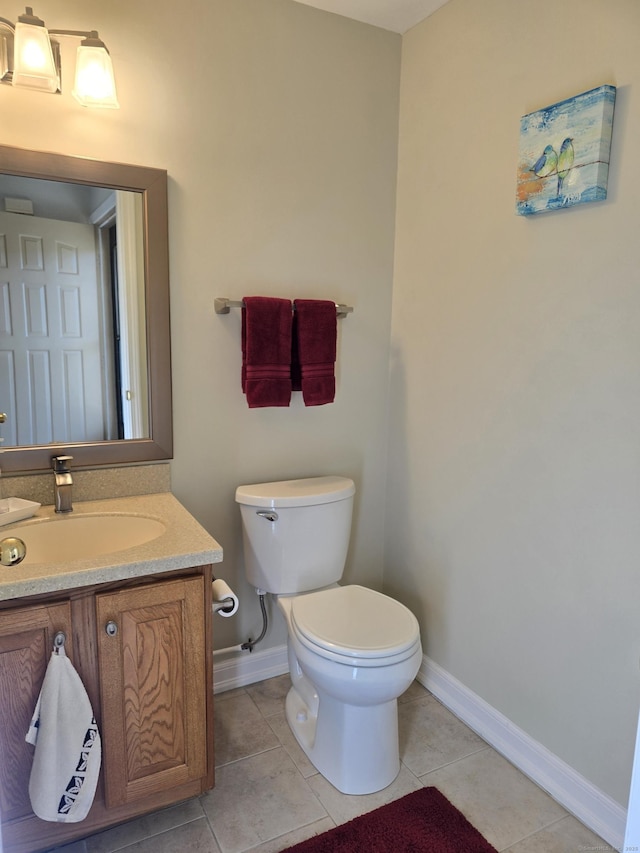 bathroom featuring vanity, toilet, and tile patterned flooring