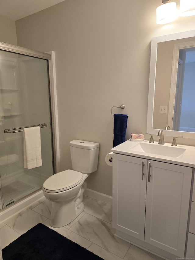 bathroom featuring an enclosed shower, vanity, and toilet