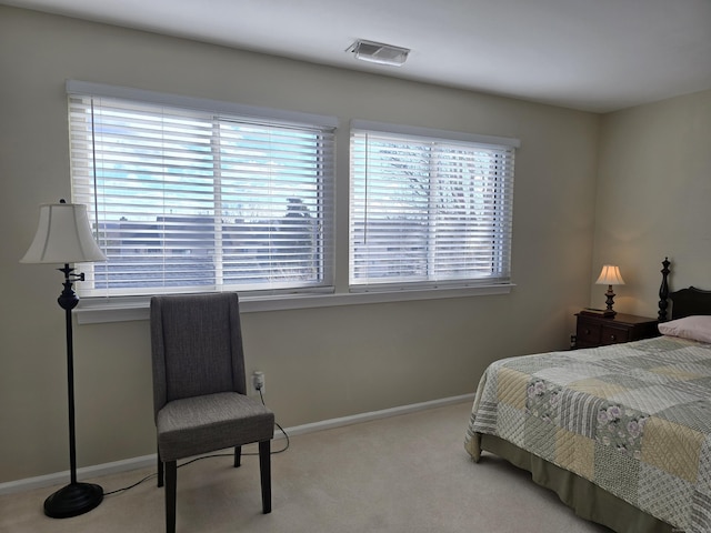 carpeted bedroom featuring multiple windows