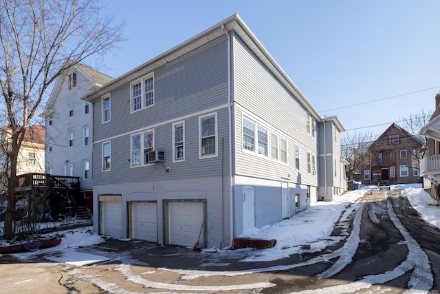 view of snowy exterior with a garage