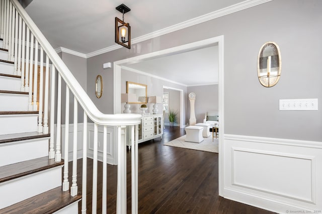 entryway with dark hardwood / wood-style flooring and ornamental molding