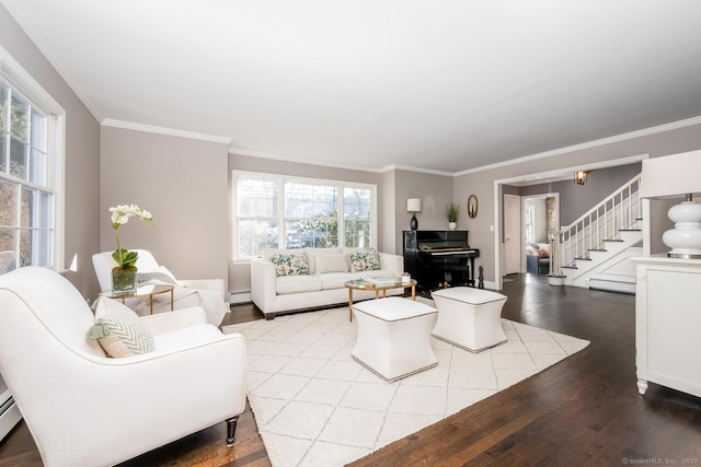 living room with crown molding, baseboard heating, and hardwood / wood-style floors