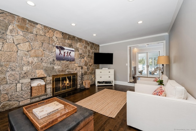 living room with dark hardwood / wood-style flooring, crown molding, and a fireplace