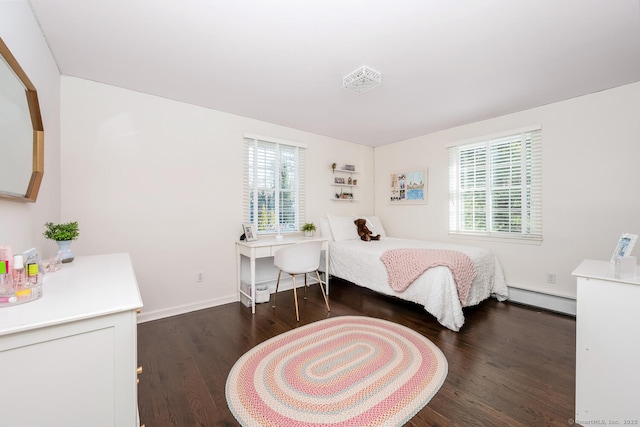 bedroom with baseboard heating and dark hardwood / wood-style floors